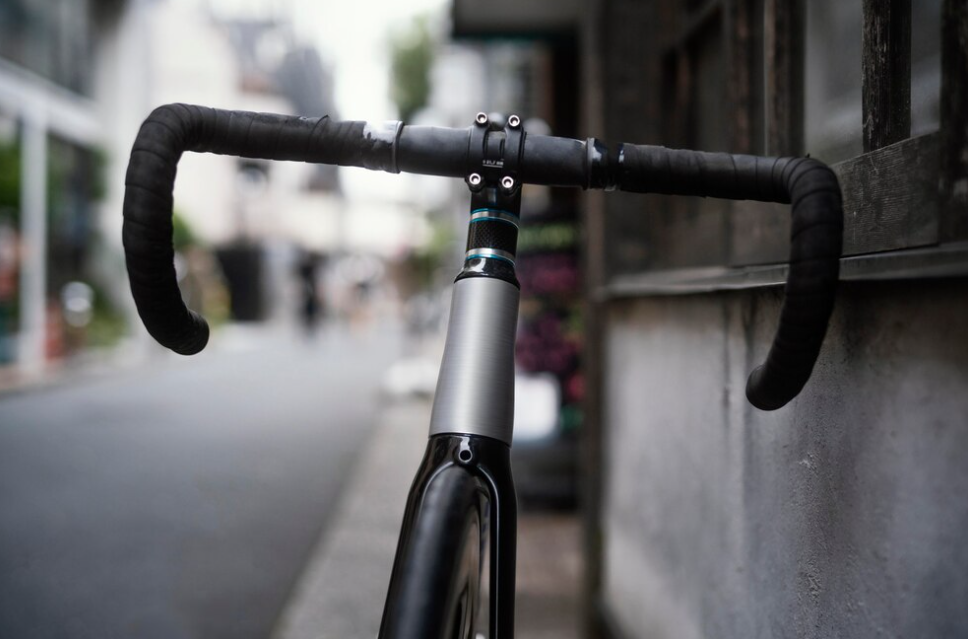 bike’s black and silver handlebar on city street near the wall