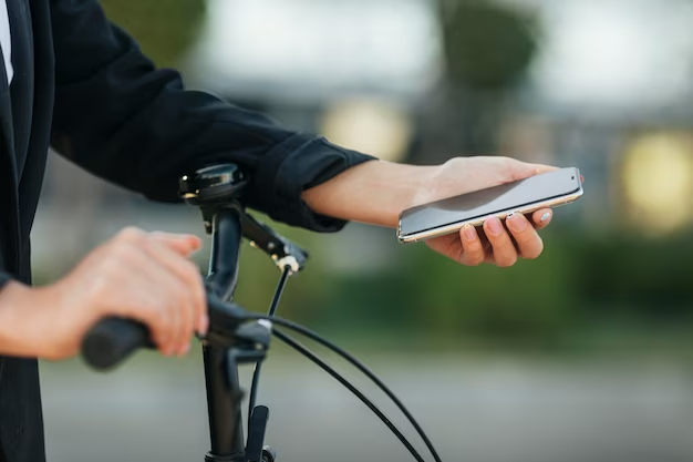 Man looking at his phone on a bicycle