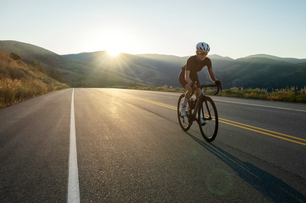 woman in helmet riding bike on road, the hills and shine shine