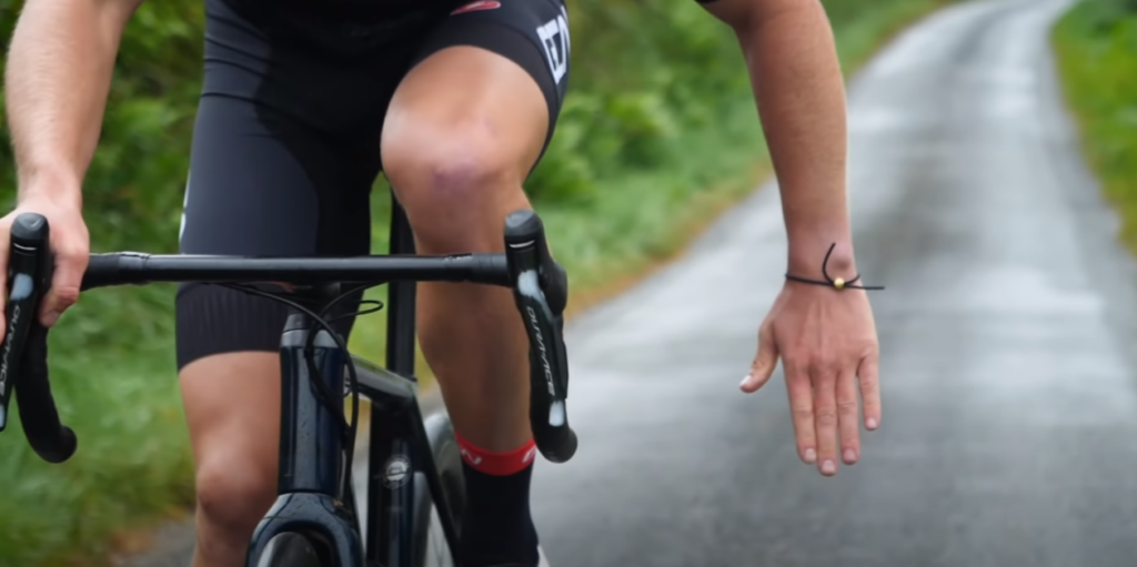 Two cyclists on the road indicating a Stop or Slow Down Signal